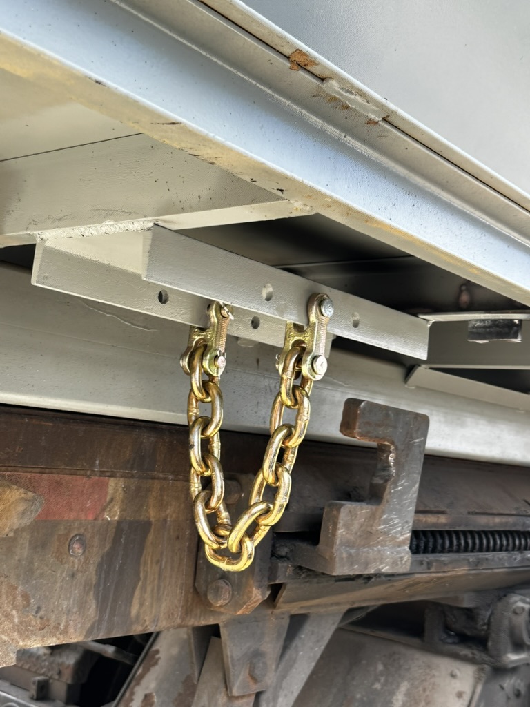 Close view of repaired compactor safety chain and structural connection