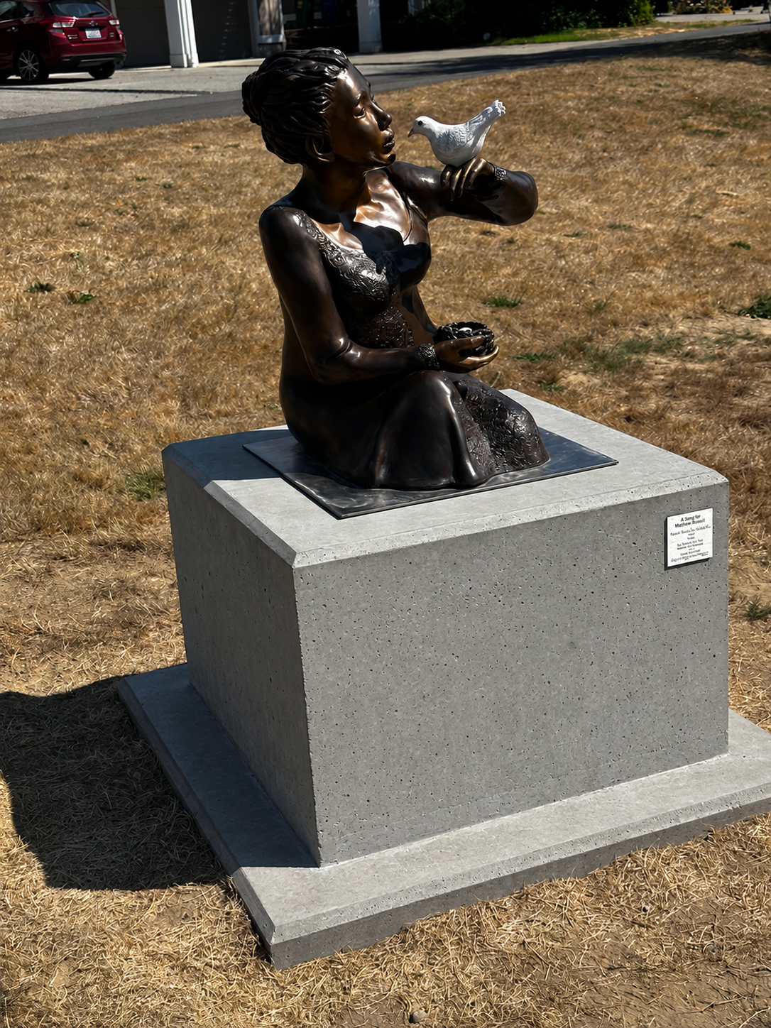 Completed metal sculpture mounted on a finished concrete pedestal