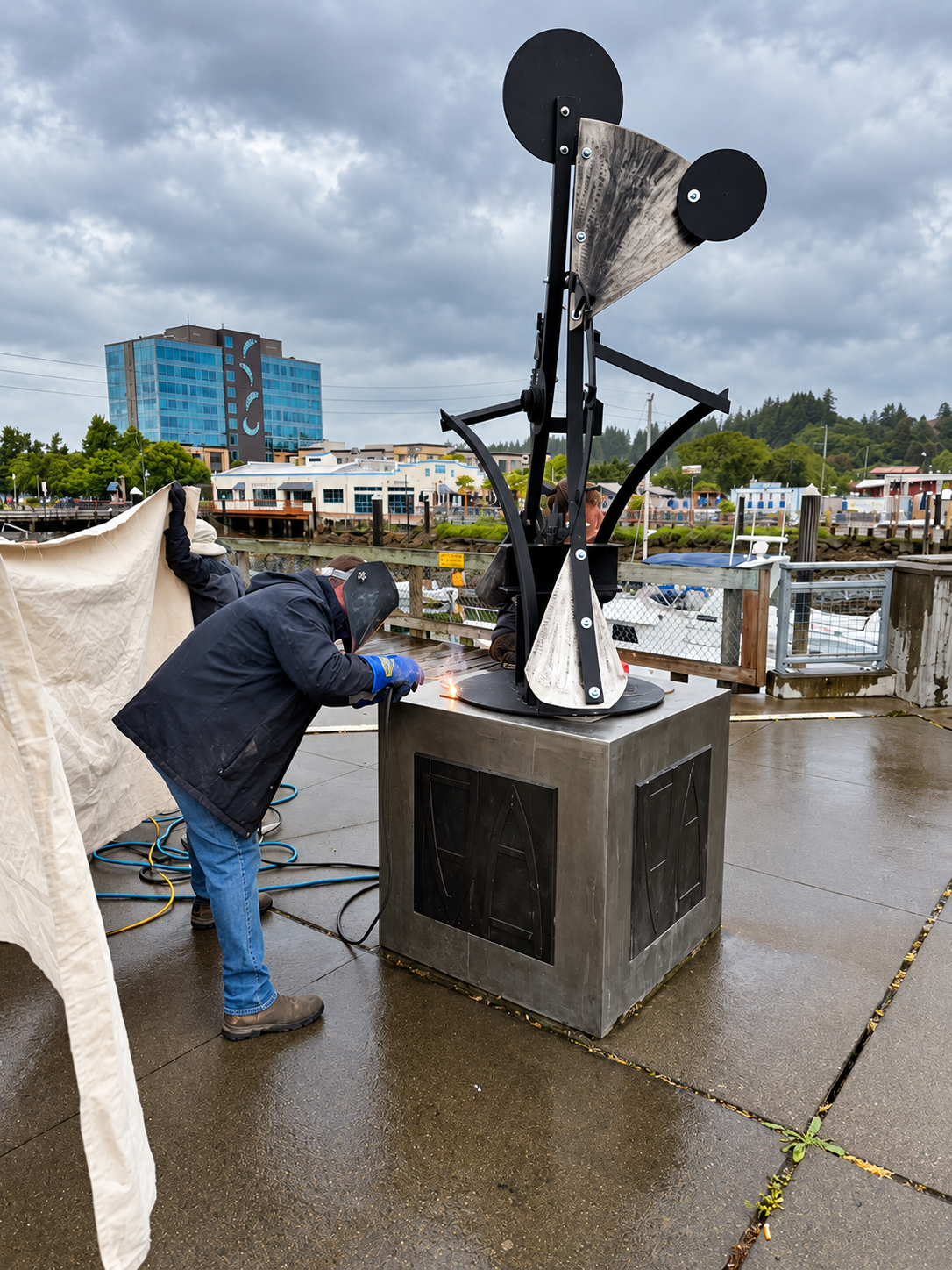 Welder completing on-site metalwork on a public sculpture